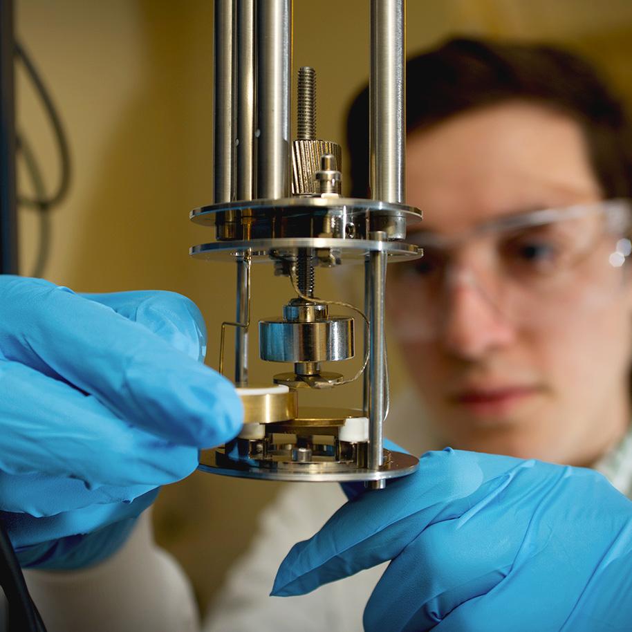 Student in Schaefer lab adjusting equipment